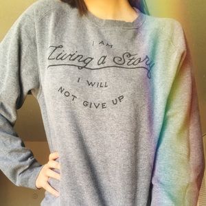 “I am living a story I will not give up” sweater